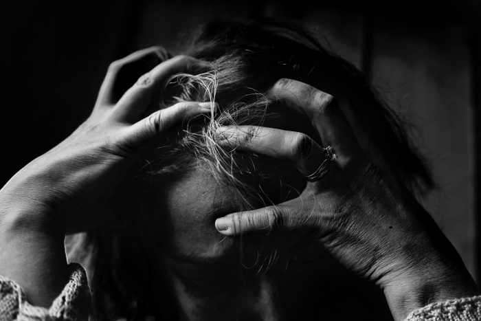 a distressed woman from a story about work stress and mental health